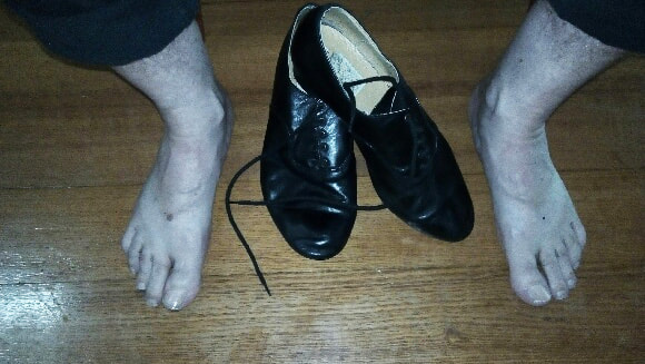 Tony's feet next to his dance shoes