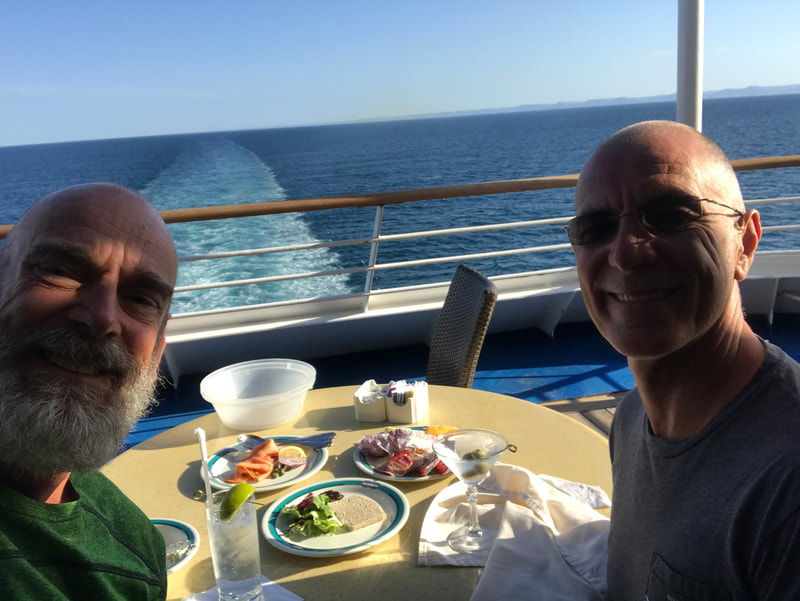 John and his partner dining while on cruise