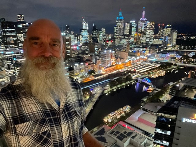 John with a view of Melbourne at night